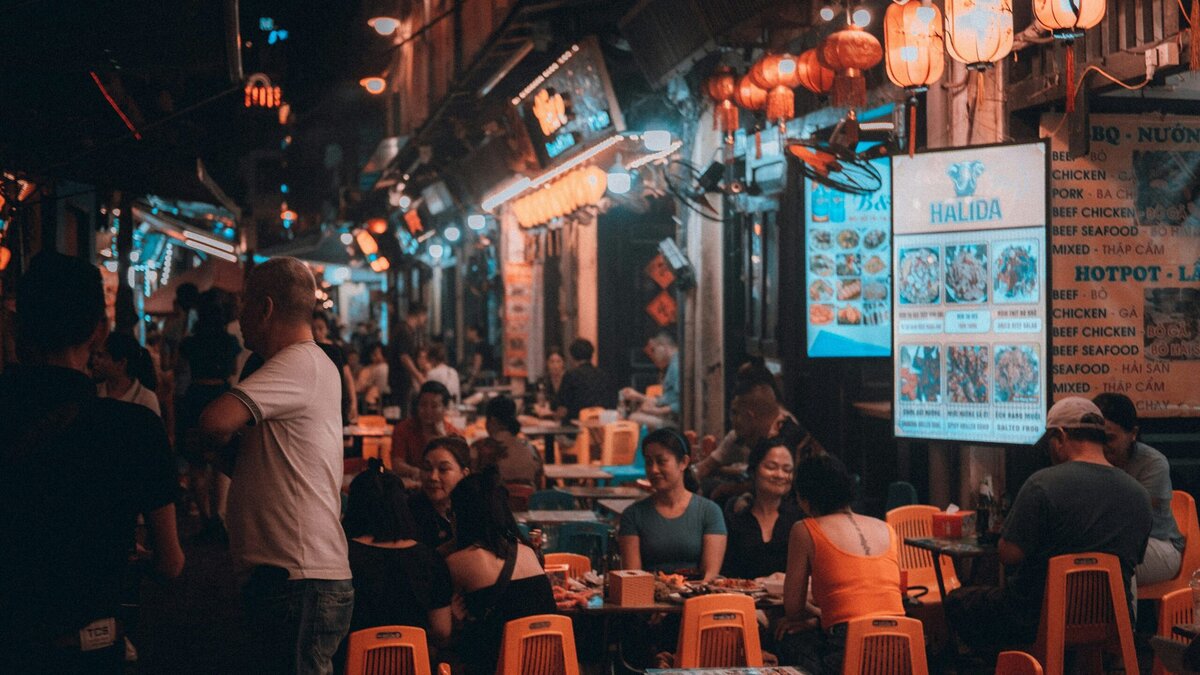 Mensen aan het eten op een nachtmarkt in Hanoi, Vietnam