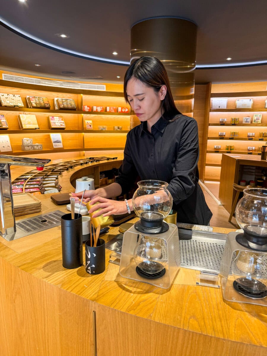 Gastvrouw zet oolong thee bij Zenique in Taipei