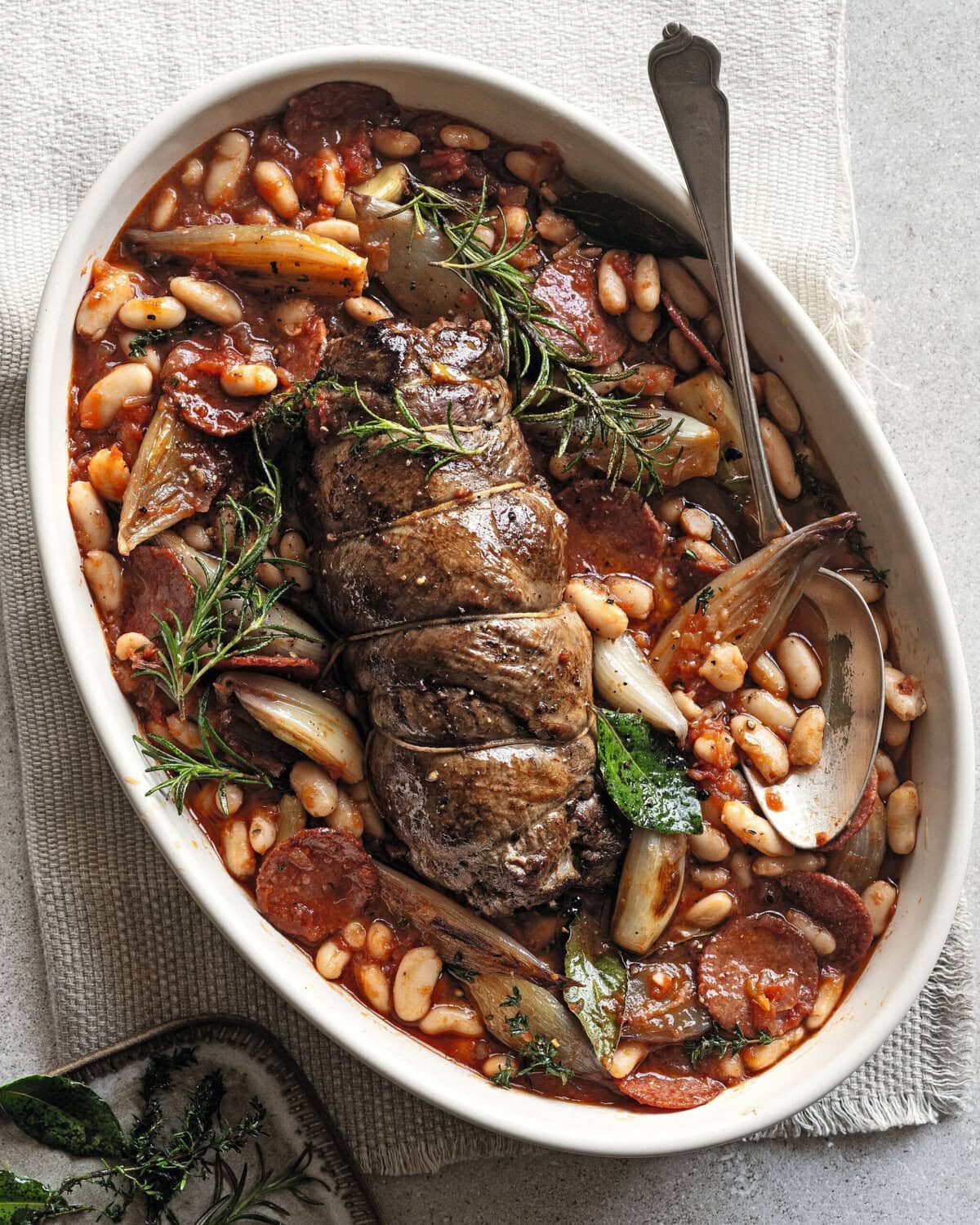 Lamsrollade in een saus van chorizo, sjalot en cannellinibonen met tijm en rozemarijn