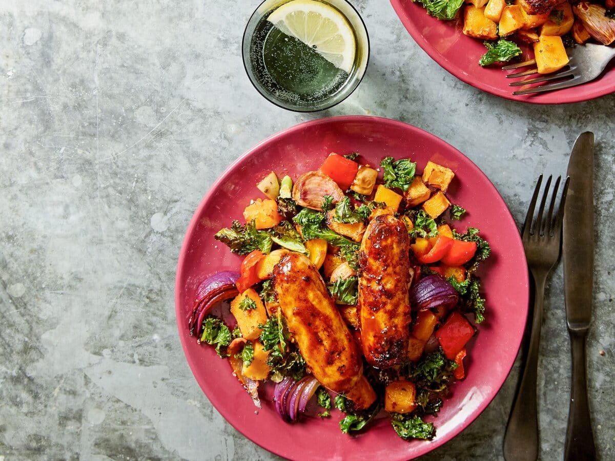 Pompoentraybake met harissaworstjes op een bord