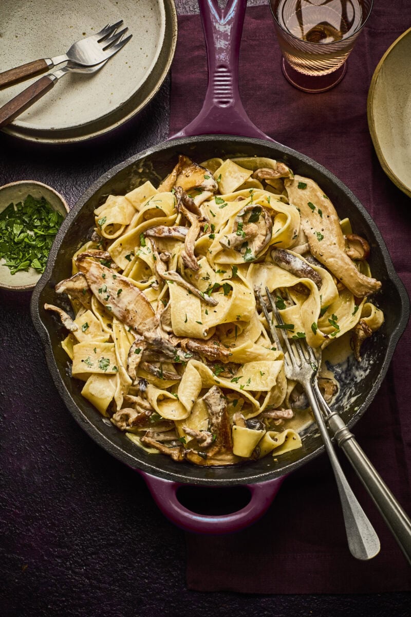 Pappardelle pasta met wilde paddenstoelen in een romige saus en peterselie